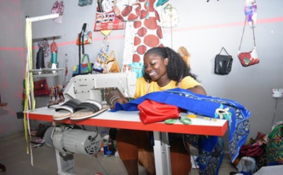 Queeneth sewing in her shop